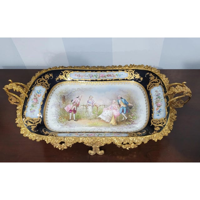 A 19th Century Sevres Hand-Painted, Cobalt & Gilt Porcelain Ormolu mounted two-handle Centerpiece signed by French Artist...