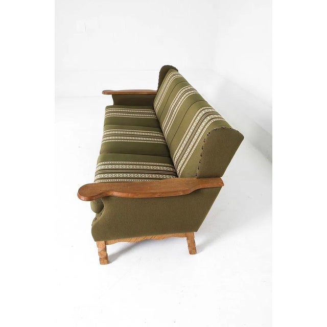 A well, and solidly, made Danish mid-century modern sofa. The piece is constructed of carved / figured oak with paddle...