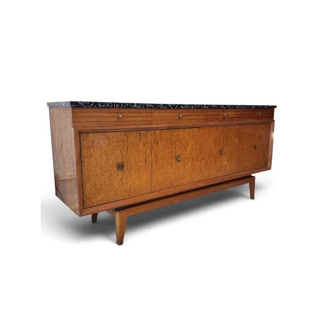An elegant British mid-century sideboard by Harris Lebus for Harrods, dating from the 1950s. Beautifully crafted from burr...