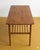 Danish coffee table from the 1950s in teak, featuring a rectangular top with rounded corners and a slatted lower shelf—a...