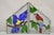 Vintage Leaded Stained Glass Red and Blue Parrot Bird Window Suncatcher - a Pair. Circa Late 20th Century. Measurements:...