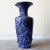 Exceptional postmodern floor vase. Features a black finish with a blue and purple paper mache around the side.