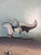 A whimsical vintage folk art kinetic sculpture depicting a stylized whale rising above curling ocean waves. The piece...