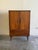 Beautiful Mid Century Modern Danish cabinet crafted in warm teak wood, featuring clean architectural lines, sculpted...