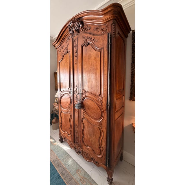 An exceptional and monumental 18th-century French Provincial carved walnut armoire of impressive architectural...