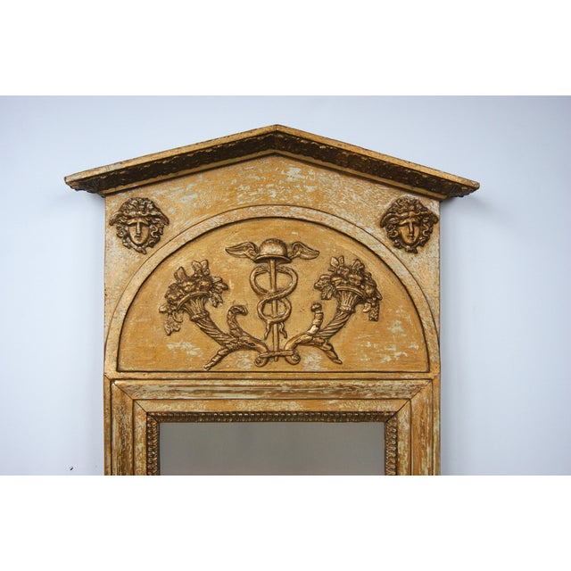 A Swedish Gustavian trumeau mirror dry scraped to its original surface with remnants of original gold gilt and later...