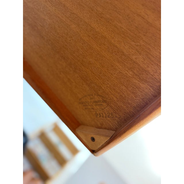 An exceptional Danish Modern expanding dining table by Nordisk Furniture of Denmark, masterfully crafted in richly figured...