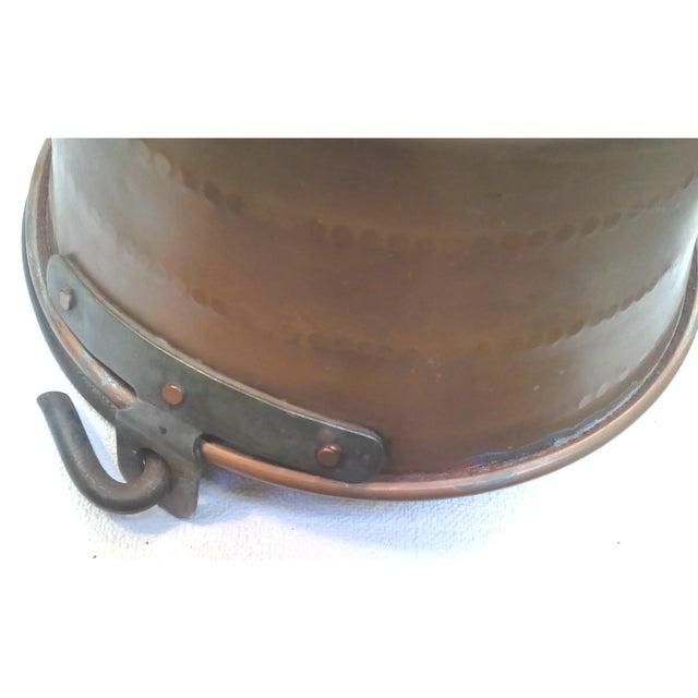 A vintage textured solid copper pot with a rounded base and riveted iron handle. This vintage jam pot is in great vintage...
