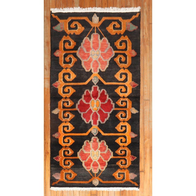 Colorful late 20th century Tibetan rug with a lovely floral design Measures: 2'11'' x 5'9".