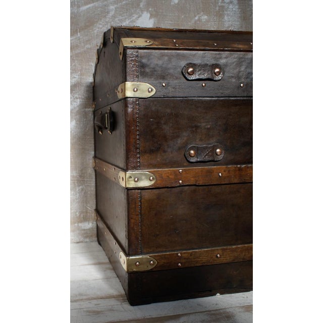A Superb Antique leather & wood-bound domed steamer trunk. Leather-bound with wood banding, brass corners, locks, and...
