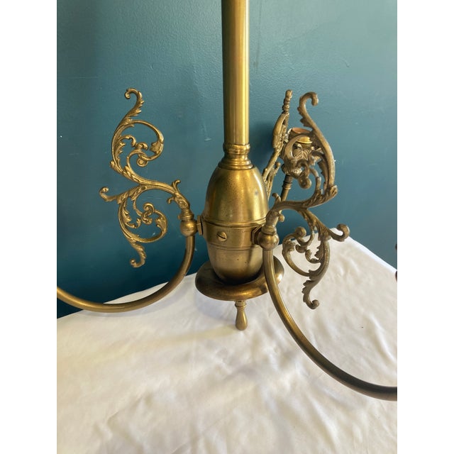 This antique brass chandelier by Wakefield Fixtures is an exceptional example of early 20th-century craftsmanship....