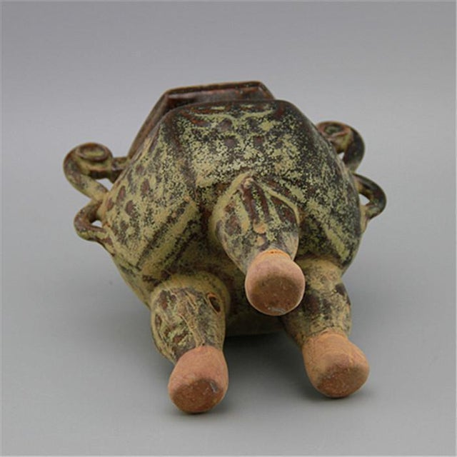This distinctive ceramic incense burner is a captivating decorative piece, featuring a rich, textured tea-dust glaze in...