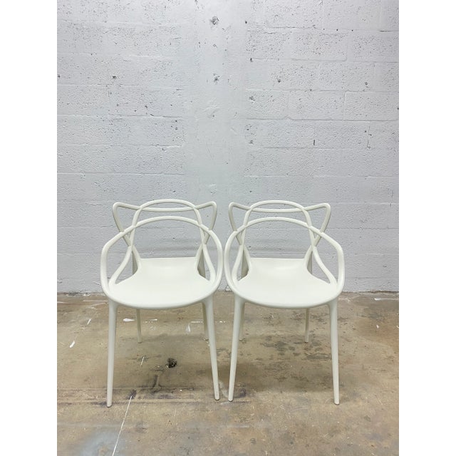 Pair of white Masters chairs by Philippe Starck and Eugeni Quitllet for Kartell. Philippe Starck and Eugeni Quitllet pay...