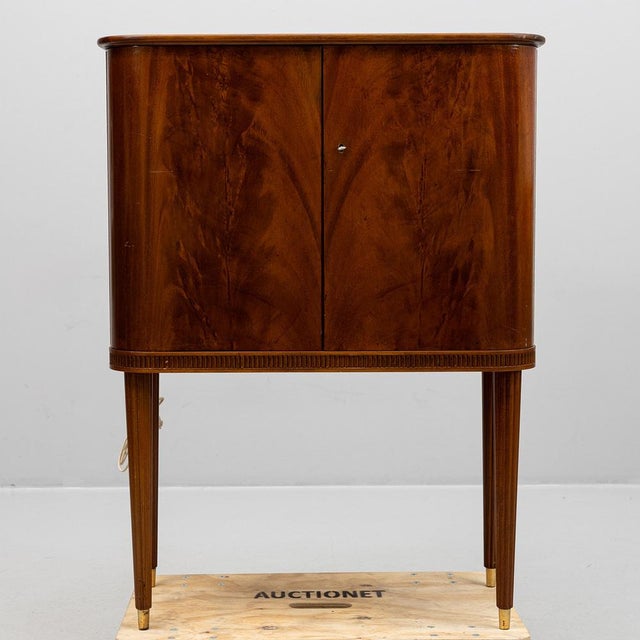 Bar Cabinet 1940s in overall good condition. Inside in teak with original mirrors and glass racks on the doors. On top a...