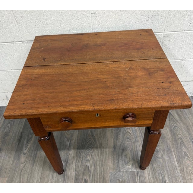 This is an antique American Country Primitive walnut one-drawer nightstand, side table, work table or side stand, likely...