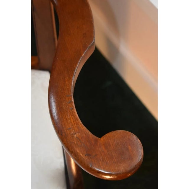 American country Hepplewhite armchair circa 1785 to 1810. The shield back is carved and pierced in an urn form. The...