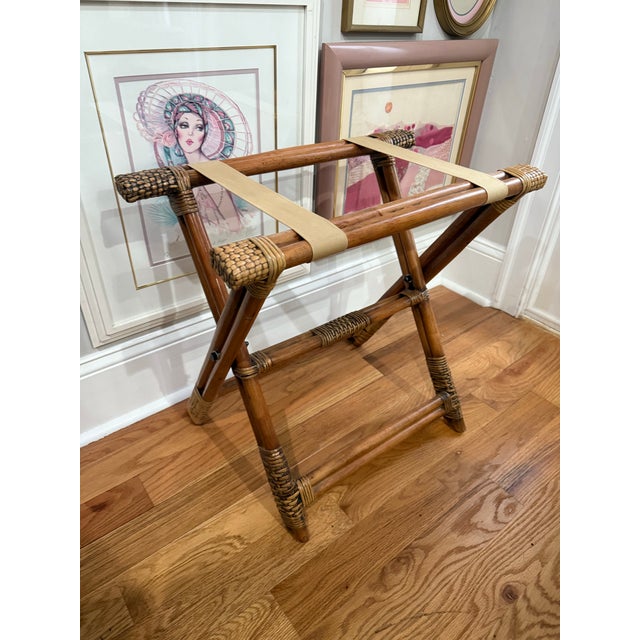 A beautifully crafted vintage folding luggage rack featuring solid bamboo poles, hand-wrapped rattan detailing, and wide...