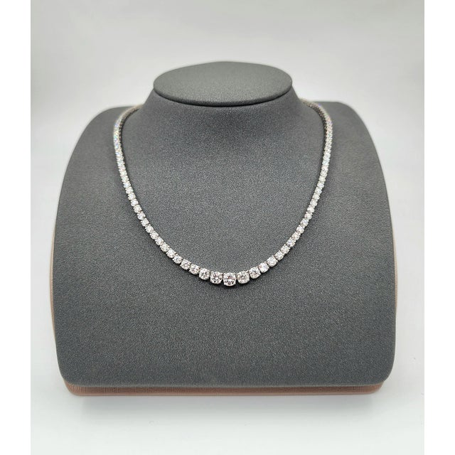A modern platinum necklace adorned with 9.75 carats of natural round-cut white diamonds, exhibiting a clarity of VS2/SI1...