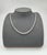 A modern platinum necklace adorned with 9.75 carats of natural round-cut white diamonds, exhibiting a clarity of VS2/SI1...
