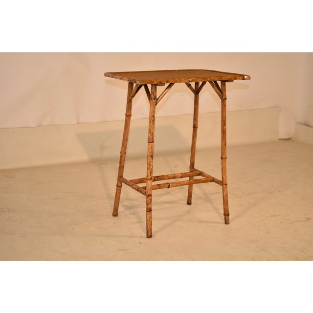 Late 19th century tortoise bamboo side table from France. The top is covered in what appears to be the original rush, and...