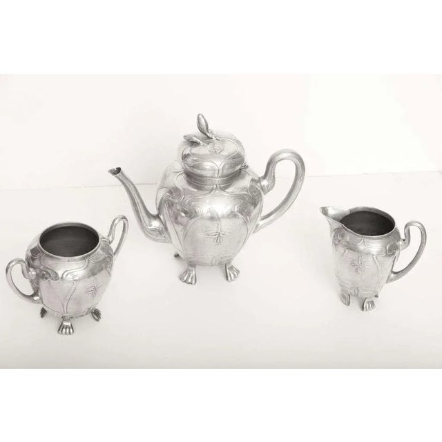 This whimsical vintage pewter European tea service consists of a covered tea pot, creamer, and sugar bowl. They are...
