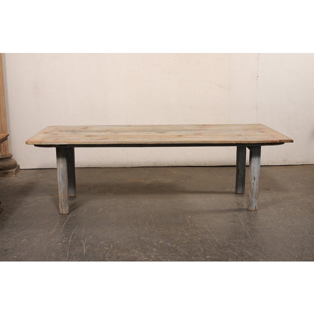 A vintage wooden farmhouse table, just over 8 feet in length. This vintage American dining table, with it's beautifully...