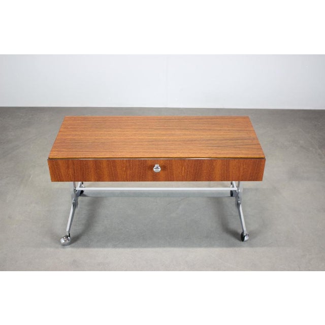 A Danish teak rolling cabinet from the 1970s, designed in the spirit of Mid Century modern Scandinavian furniture. The...