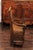 An English country pine chair from the early 19th century, with pierced back, scrolled arms and lift-top seat. This rustic...