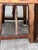 Bring striking artisanal character into your space with this vintage, handcrafted rustic trestle-style side table. The...