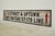 Reclaimed movie set street sign made of plastic foam board in white and black colors with red arrows. The sign reads "To...