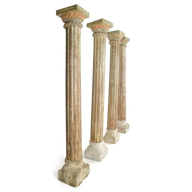 Imposing and beautifully patinated, these four columns with fluted shafts and sculpted capitals feature a carved stone...