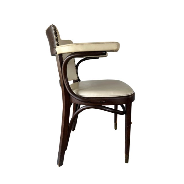 A sturdy Thonet Arm Chair for dining or desk use, with a contrasting upholstery to wood combination. Nail heads up the...