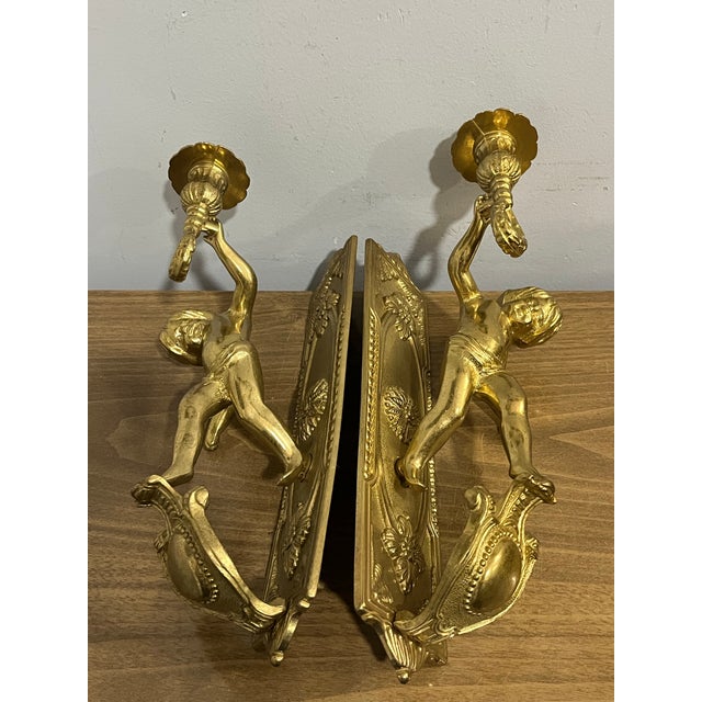 This vintage pair of Italian solid brass cherub wall sconces exudes old-world charm and elegance. Crafted with intricate...
