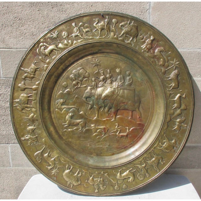Mid- to early 20th-century brass charger. Copper/brass alloy metal tray, 30" in diameter. Raja hunting in the field on...