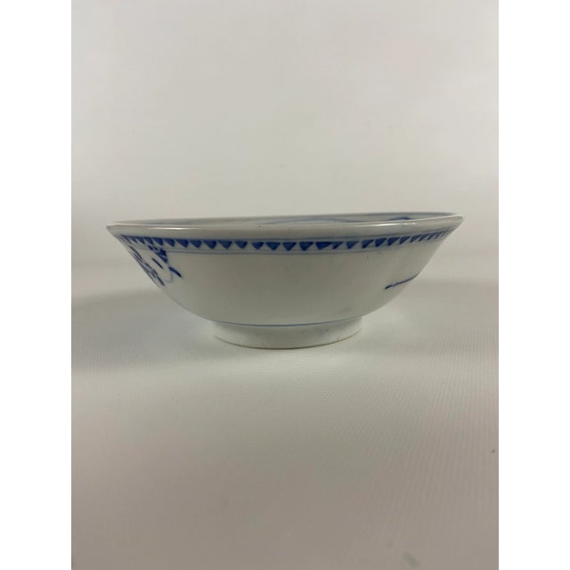 Single small round Chinese porcelain bowl with traditional blue and white hand painted floral decoration.
