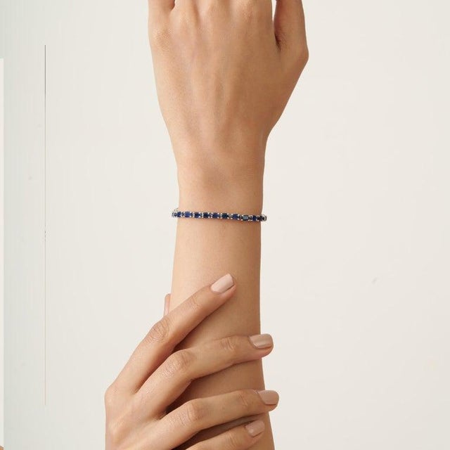 A classic blue sapphire tennis bracelet crafted in 925 sterling silver, defined by its graceful proportions and enduring...