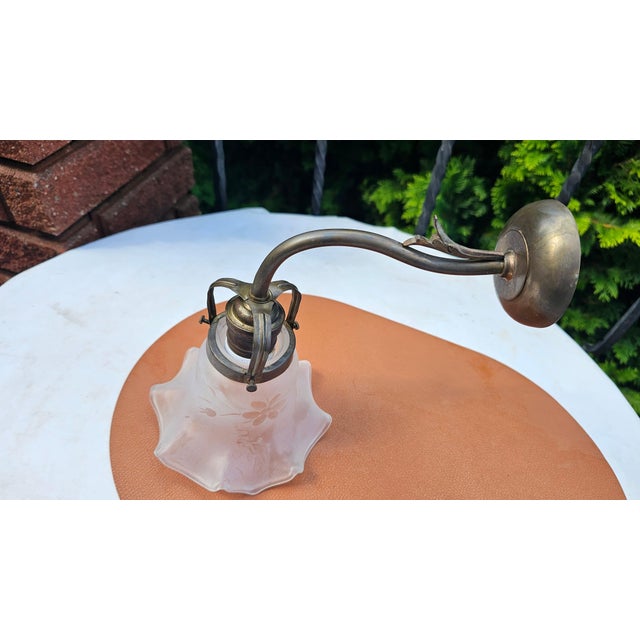 Art Deco brass wall sconce, dimensions: height 23 cm, depth 26 cm, shade diameter 15 cm. European Plug (up to 250V).The...