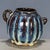 A striking small Chinese ceramic jug or pitcher. The vessel features a ribbed, melon-like body with a small pouring spout...