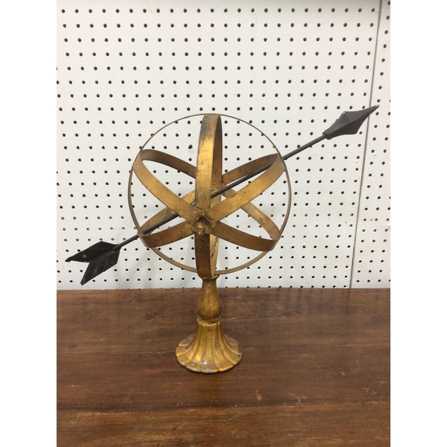 Italian gilt metal armillary with a black arrow meridian.
