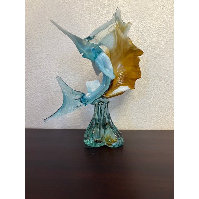 This white, brown and blue Murano style swordfish stands 11" tall 9" wide and 4" deep. It is in pristine condition with no...