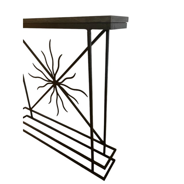 A fabulous Mid-Century Giacometti inspired console table! A hand-forged sculptured metal base with a hammered texture. At...