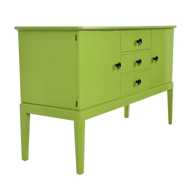 Green lacquered wooden buffet. This piece is designed in the style of the selected designer and/or manufacturer