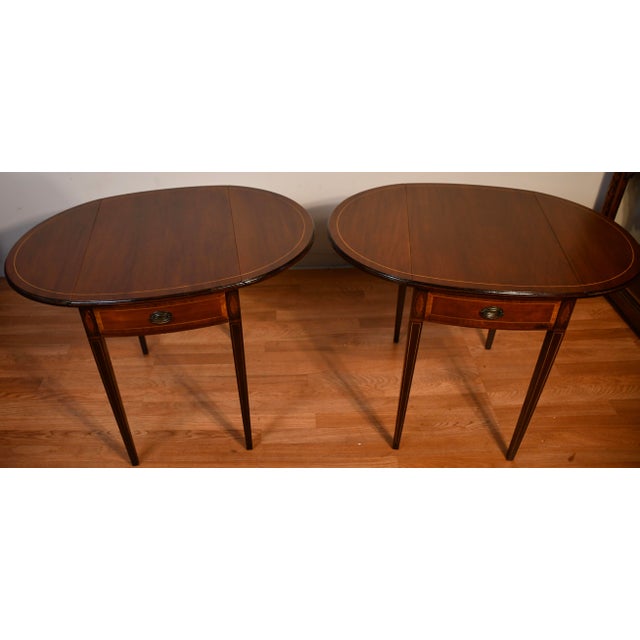 We are pleased to offer this beautiful pair of Antique English Hepplewhite Pembroke drop-leaf Side Tables, from the 1920s....