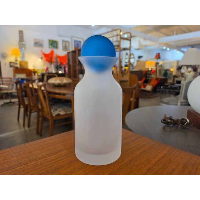 Add a touch of Scandinavian-inspired post-modern elegance to your home decor with this striking frosted glass bottle....