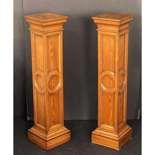 A pair of fine English four-sided column pedestal stands or plinths of moulded long-leaf pine - each side with a paneled...