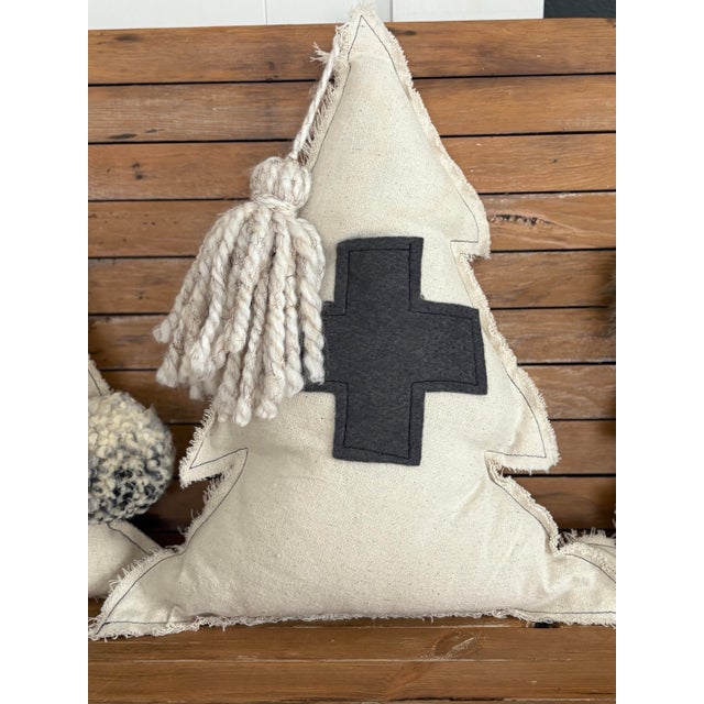 This set of three handcrafted decorative pillows features a sculptural tree form accented with a Swiss cross appliqué,...