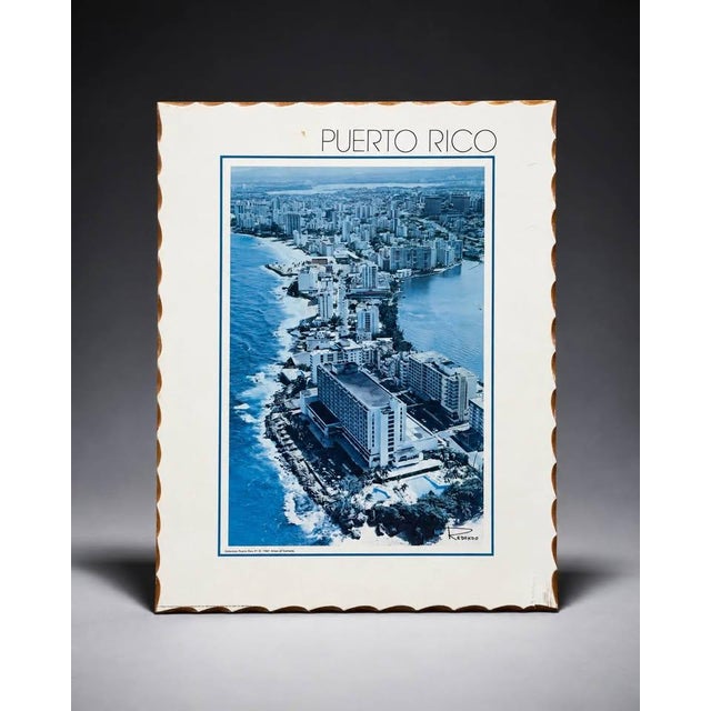 intage-style Puerto Rico wall art featuring a blue-toned aerial coastal city view. The piece shows an oceanfront cityscape...