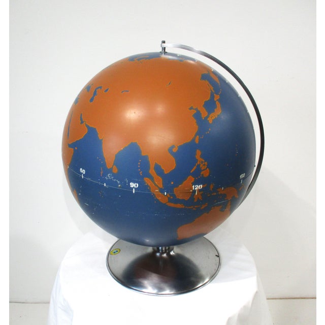 A large stunning hollow painted metal globe with turned aluminum base and holder, the globe is in a rare hard to find blue...