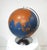A large stunning hollow painted metal globe with turned aluminum base and holder, the globe is in a rare hard to find blue...