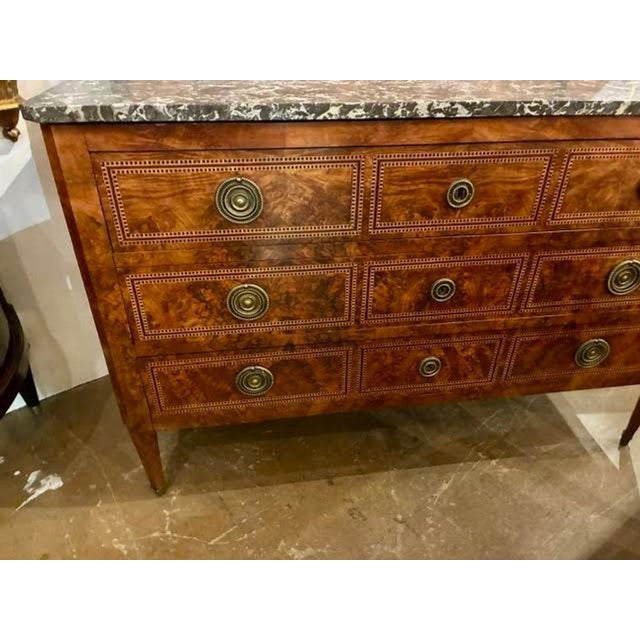 This 19th c. French Transitional Walnut Inlaid Commode is a beautiful and functional piece of furniture. Featuring...